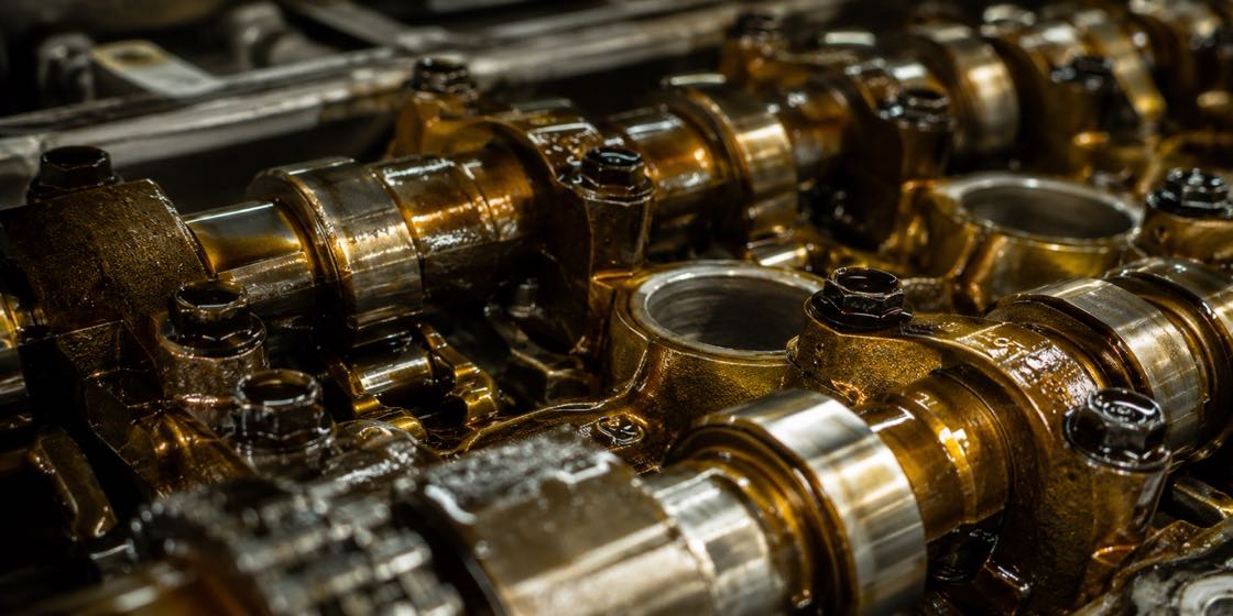 Fresh golden synthetic oil coating clean metal engine parts