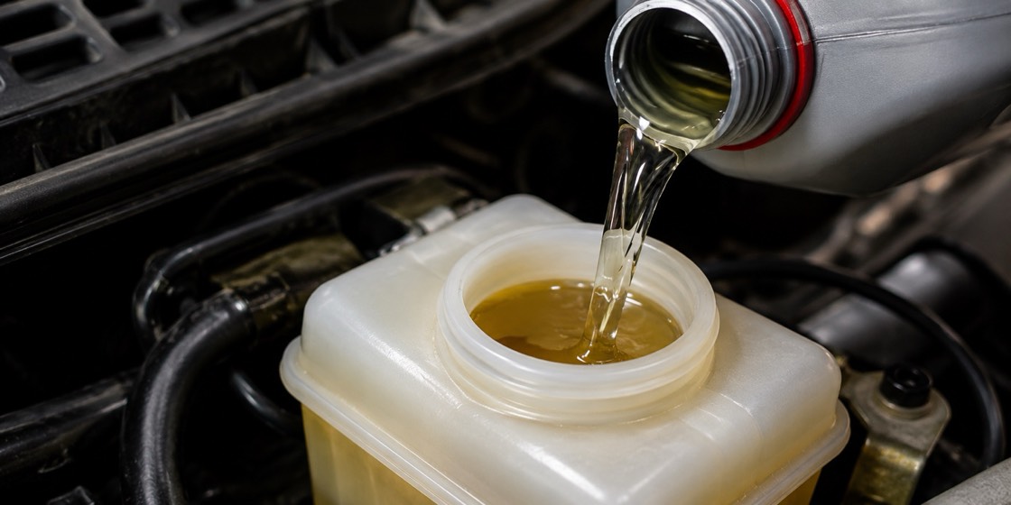 Fresh brake fluid being poured into the reservoir